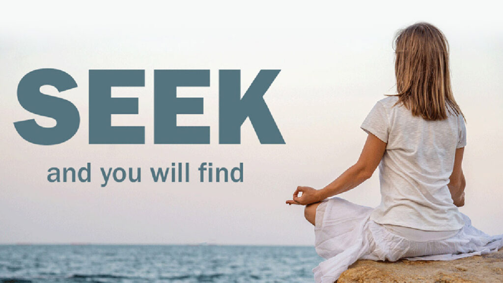 Women meditating by the ocean